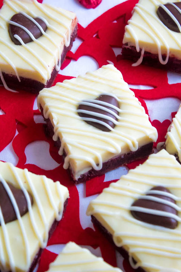 These White Chocolate Fudge Red Velvet Brownies are an upgrade from the classic cake. Rich, fudgy and decadent red velvet brownies, topped with a chewy white chocolate fudge and a drizzle of cream cheese icing for the perfect finishing touch!