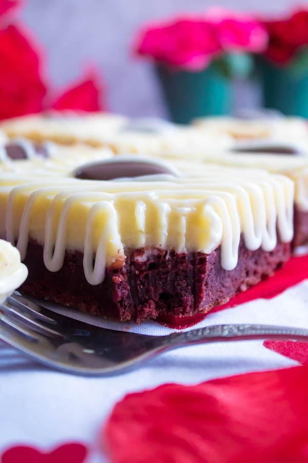 These White Chocolate Fudge Red Velvet Brownies are an upgrade from the classic cake. Rich, fudgy and decadent red velvet brownies, topped with a chewy white chocolate fudge and a drizzle of cream cheese icing for the perfect finishing touch!