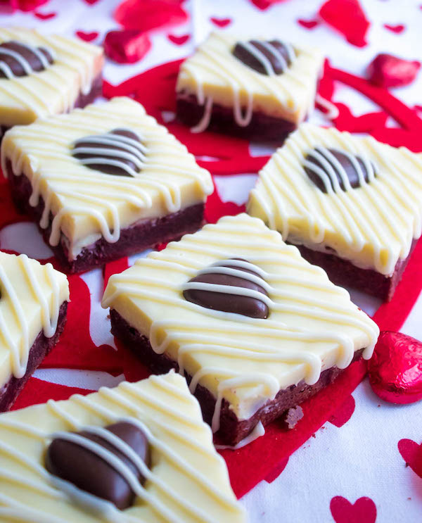 These White Chocolate Fudge Red Velvet Brownies are an upgrade from the classic cake. Rich, fudgy and decadent red velvet brownies, topped with a chewy white chocolate fudge and a drizzle of cream cheese icing for the perfect finishing touch!