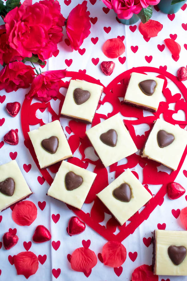 These White Chocolate Fudge Red Velvet Brownies are an upgrade from the classic cake. Rich, fudgy and decadent red velvet brownies, topped with a chewy white chocolate fudge and a drizzle of cream cheese icing for the perfect finishing touch!