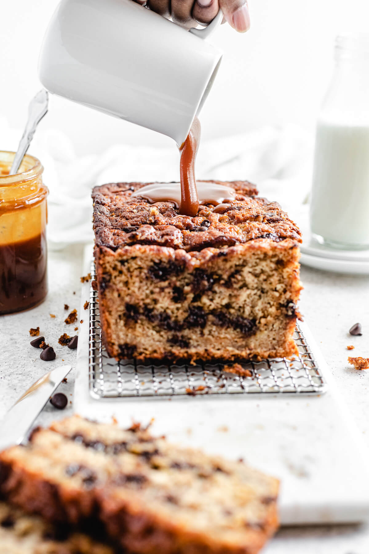 pouring caramel sauce on top of loaf