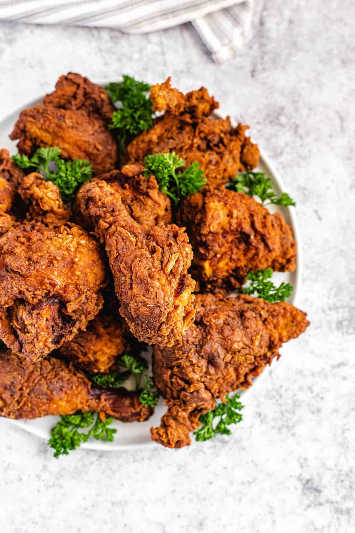 top view of fried chicken and parsley on a platter