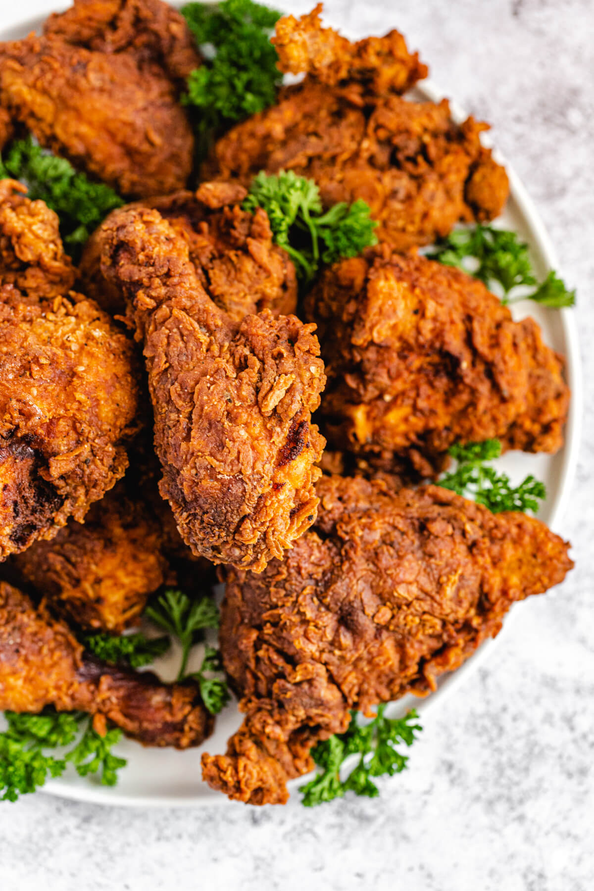 close up top view of chicken on a plate with fresh parsley between the chicken