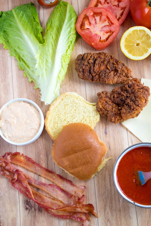 These Spicy Fried Chicken Sandwiches are crispy, juicy and seasoned to perfection. Sandwiched between toasted brioche buns, fresh lettuce, tomatoes, mozzarella, crispy bacon and a flavourful spicy aioli — these fried chicken sandwiches are comfort food at its best!