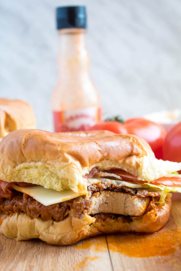 These Spicy Fried Chicken Sandwiches are crispy, juicy and seasoned to perfection. Sandwiched between toasted brioche buns, fresh lettuce, tomatoes, mozzarella, crispy bacon and a flavourful spicy aioli — these fried chicken sandwiches are comfort food at its best!