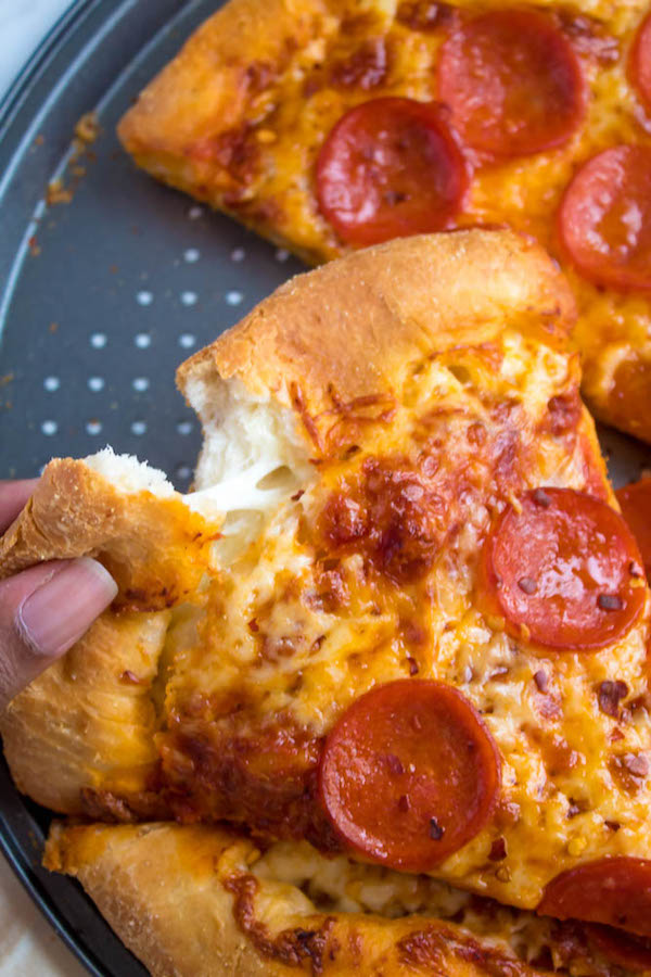 Pizza Night just got a whole lot better! This Homemade Pizza is topped with a flavourful sauce, two types of cheeses and slices of pepperoni. What makes this classic pepperoni pizza so special? The crust is stuffed with cheese!