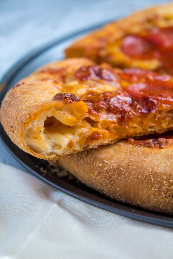 Pizza Night just got a whole lot better! This Homemade Pizza is topped with a flavourful sauce, two types of cheeses and slices of pepperoni. What makes this classic pepperoni pizza so special? The crust is stuffed with cheese!