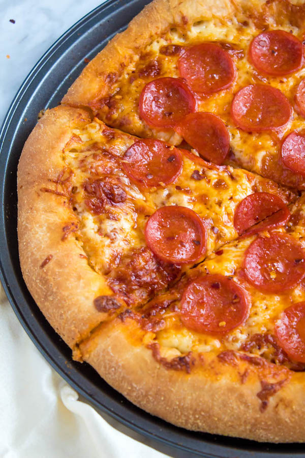 Pizza Night just got a whole lot better! This Homemade Pizza is topped with a flavourful sauce, two types of cheeses and slices of pepperoni. What makes this classic pepperoni pizza so special? The crust is stuffed with cheese!