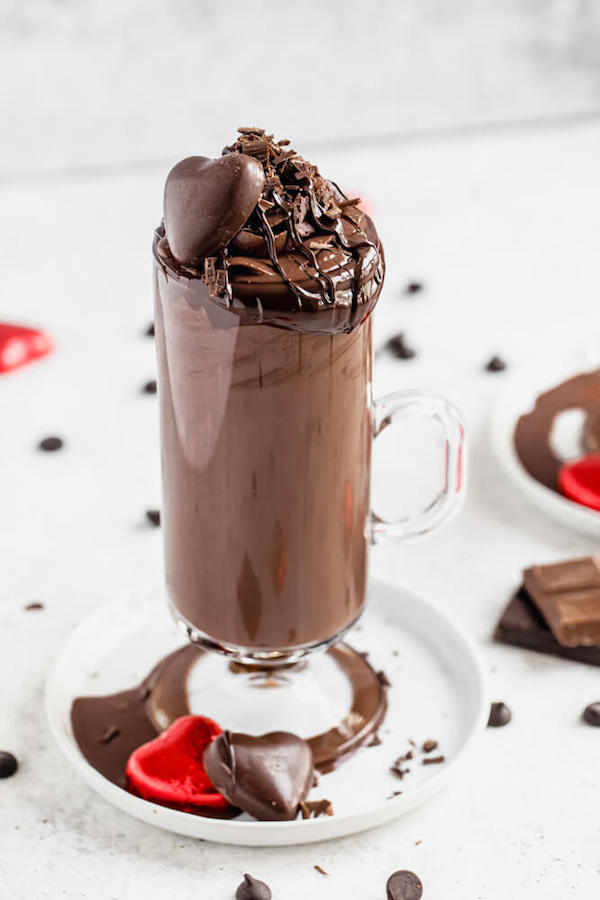 mug of hot chocolate on a white appetizer plate 