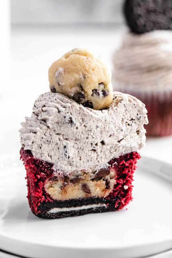 halved cookie dough filled cupcake on a small white plate