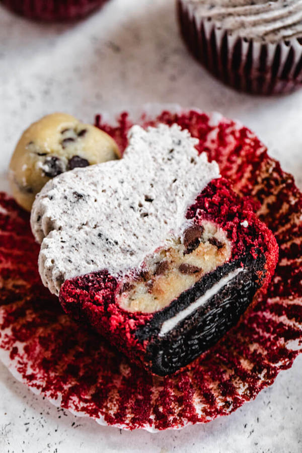 close up of red velvet cookie dough Oreo cupcake cut in half