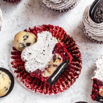 red velvet cupcake cut in half showing Oreo cookie and cookie dough ball inside