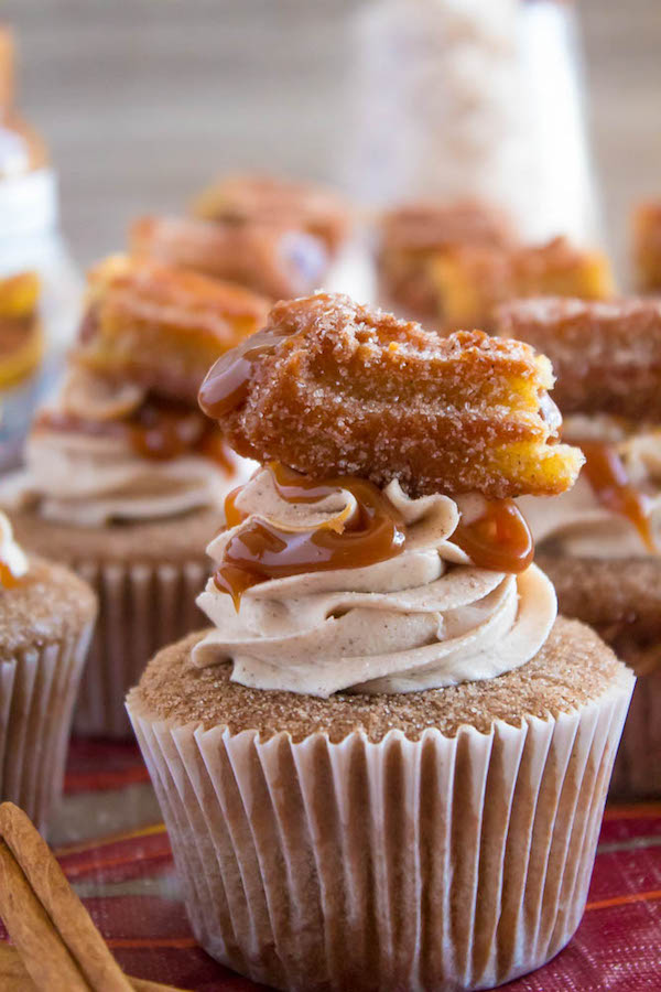 Take your favourite cinnamon/sugar treat and turn it into cupcakes! These Dulce de Leche Churro Cupcakes are a must for Cinco de Mayo! Soft and fluffy cinnamon cupcakes, filled with gooey dulce de leche, dipped in cinnamon sugar, topped with cinnamon buttercream and a dulce de leche filled churro!