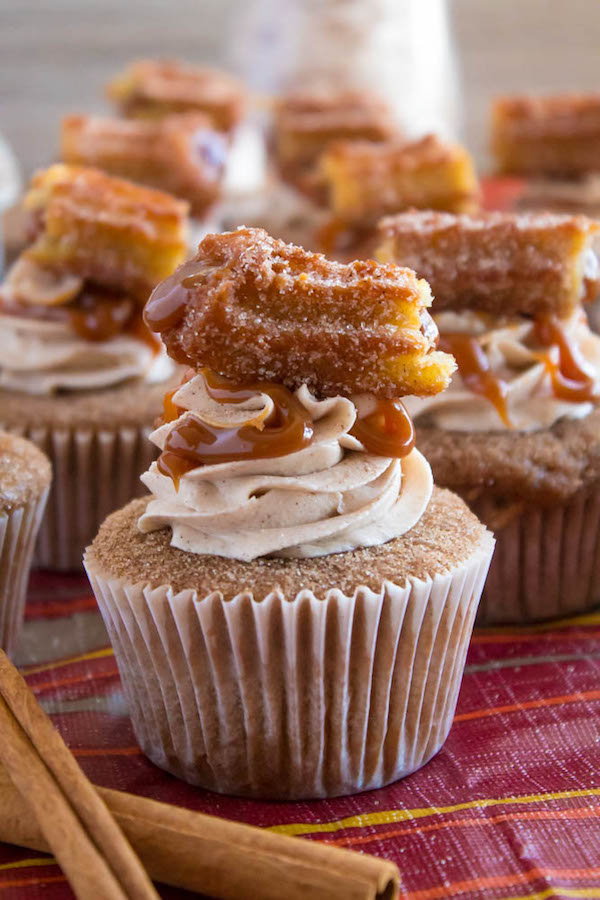 Take your favourite cinnamon/sugar treat and turn it into cupcakes! These Dulce de Leche Churro Cupcakes are a must for Cinco de Mayo! Soft and fluffy cinnamon cupcakes, filled with gooey dulce de leche, dipped in cinnamon sugar, topped with cinnamon buttercream and a dulce de leche filled churro!