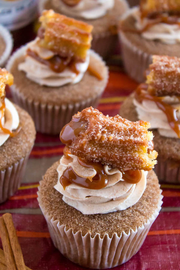 Take your favourite cinnamon/sugar treat and turn it into cupcakes! These Dulce de Leche Churro Cupcakes are a must for Cinco de Mayo! Soft and fluffy cinnamon cupcakes, filled with gooey dulce de leche, dipped in cinnamon sugar, topped with cinnamon buttercream and a dulce de leche filled churro!