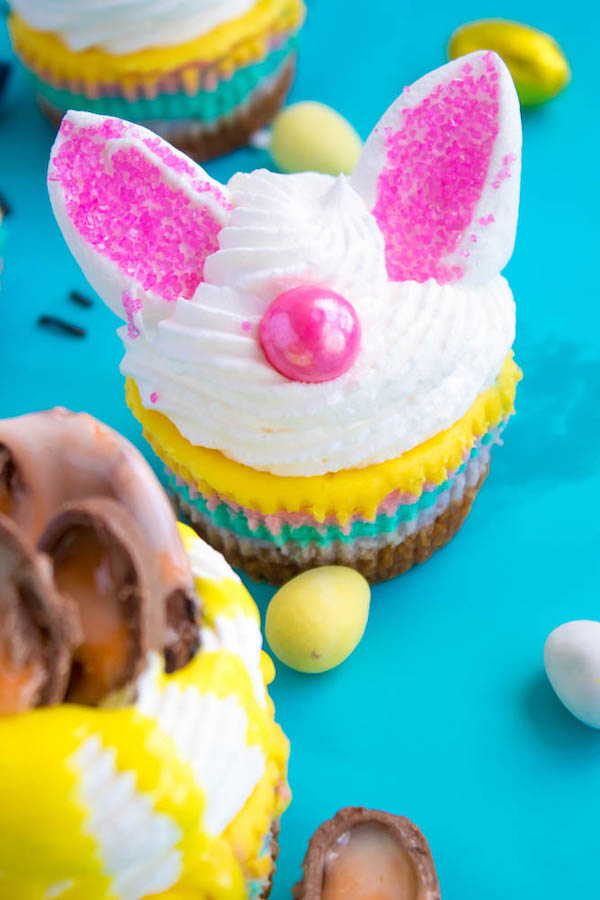 These Mini Easter Cheesecakes are a colourful, fun, festive Easter and Spring treat! Creamy, pastel layered mini cheesecakes topped with yummy Easter candy!