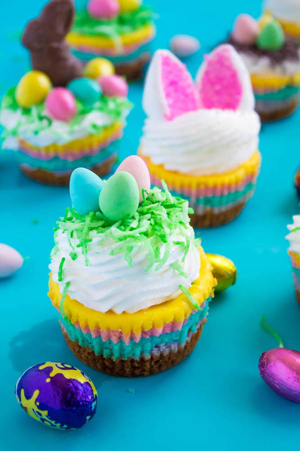 These Mini Easter Cheesecakes are a colourful, fun, festive Easter and Spring treat! Creamy, pastel layered mini cheesecakes topped with yummy Easter candy!