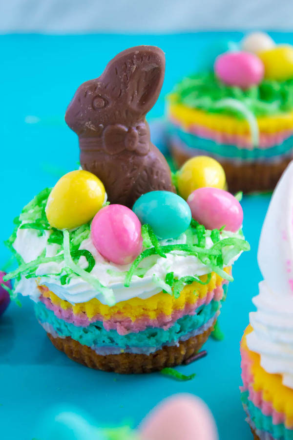 These Mini Easter Cheesecakes are a colourful, fun, festive Easter and Spring treat! Creamy, pastel layered mini cheesecakes topped with yummy Easter candy!