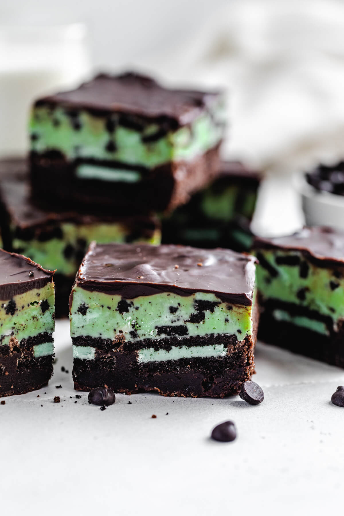 slices of fudge topped brownies stuffed with mint cookies