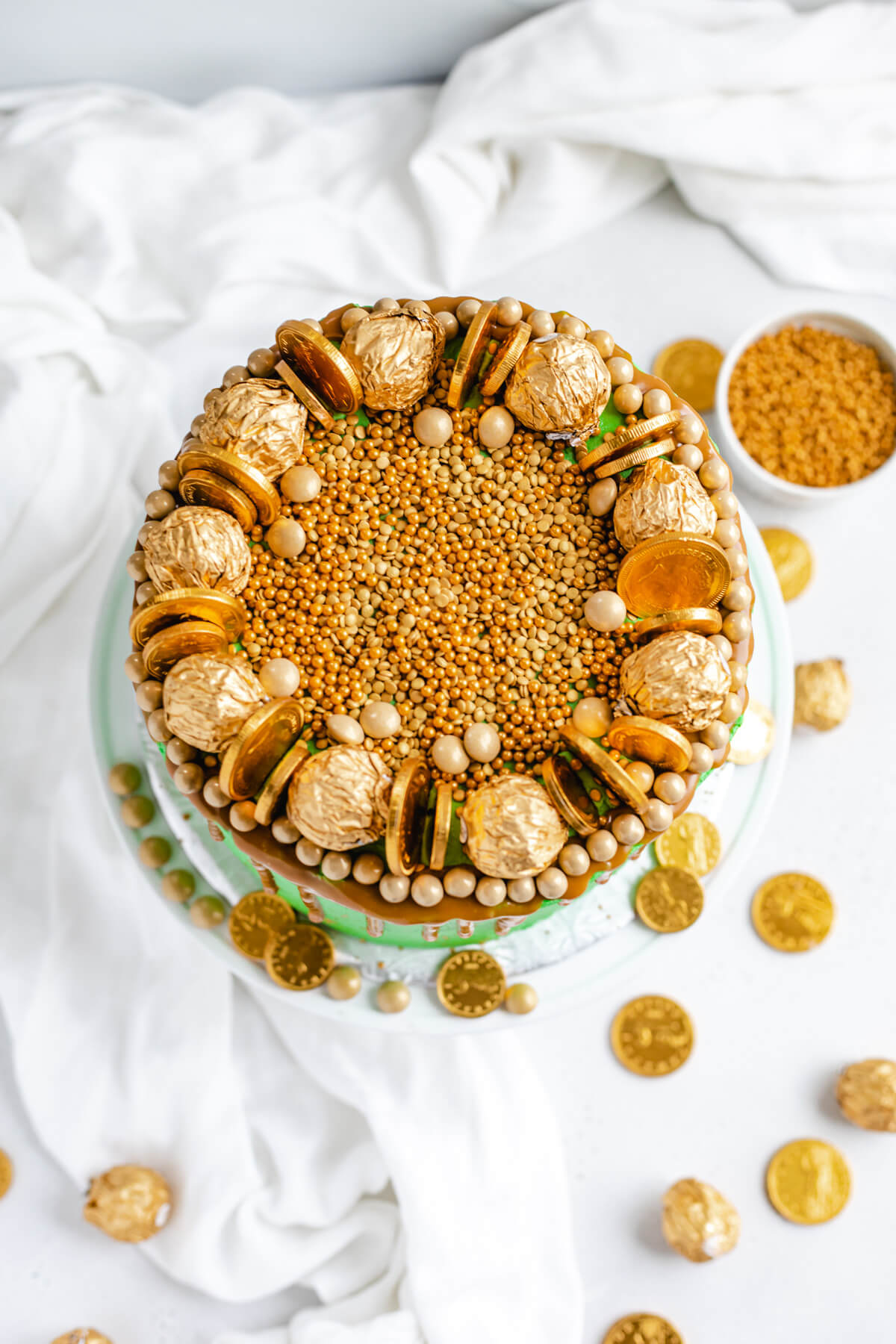 top of cake covered in gold sprinkles