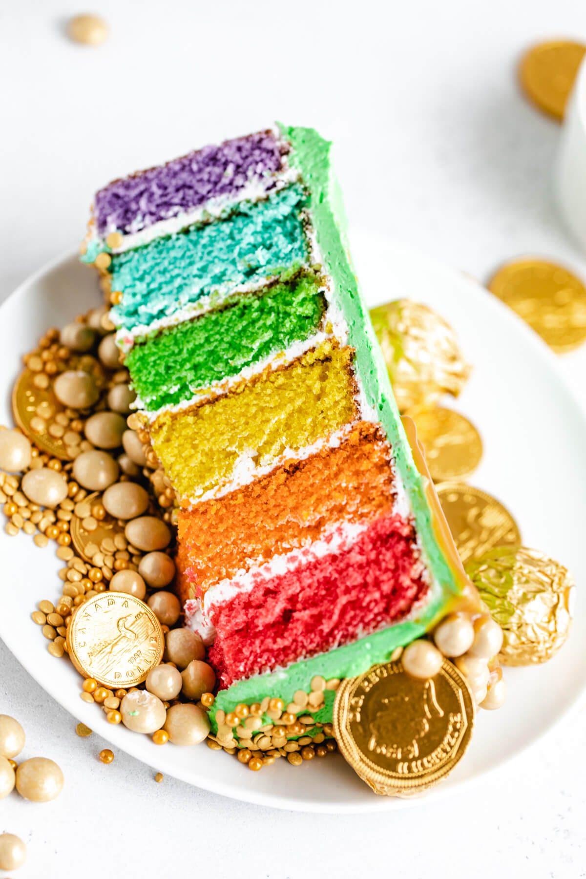 slice of rainbow cake on a white plate