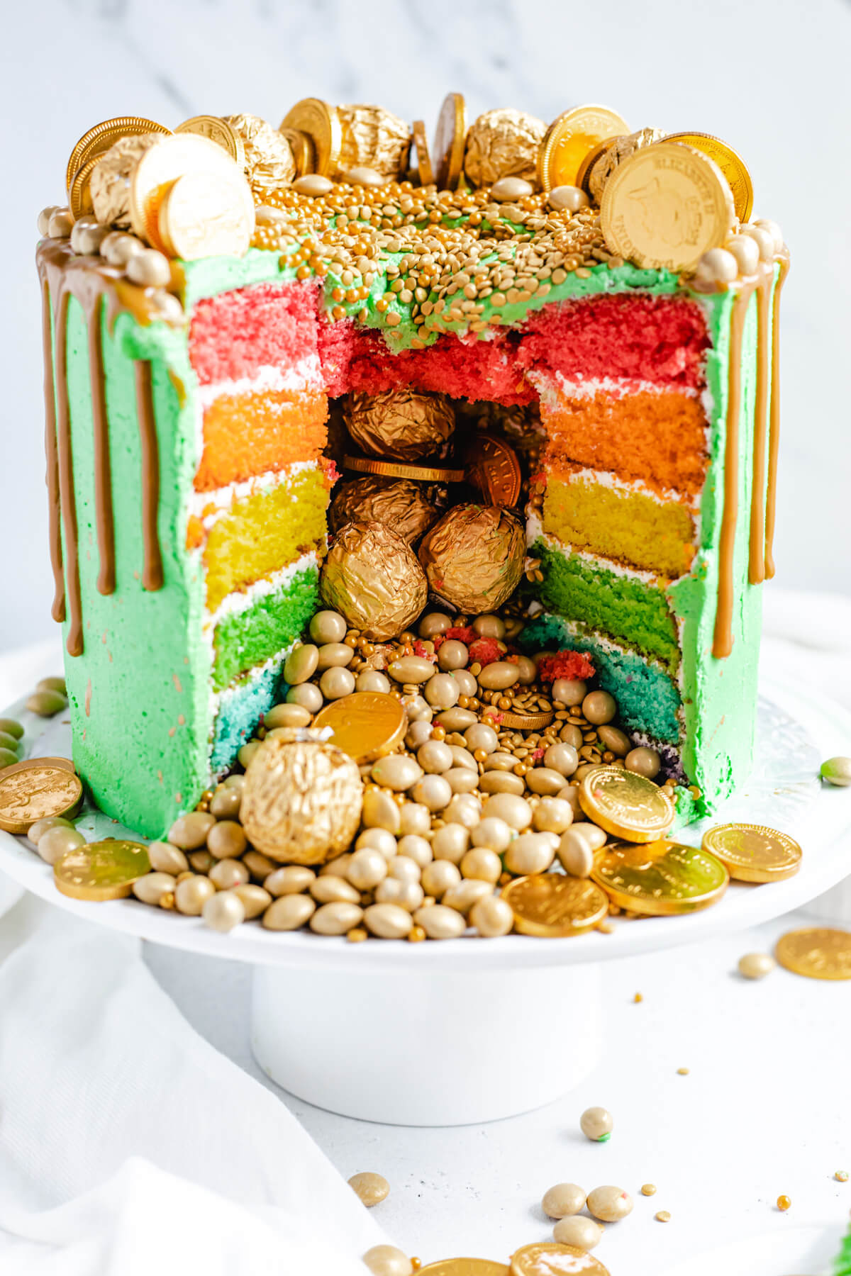 gold candies and sprinkles spilling out of a cake