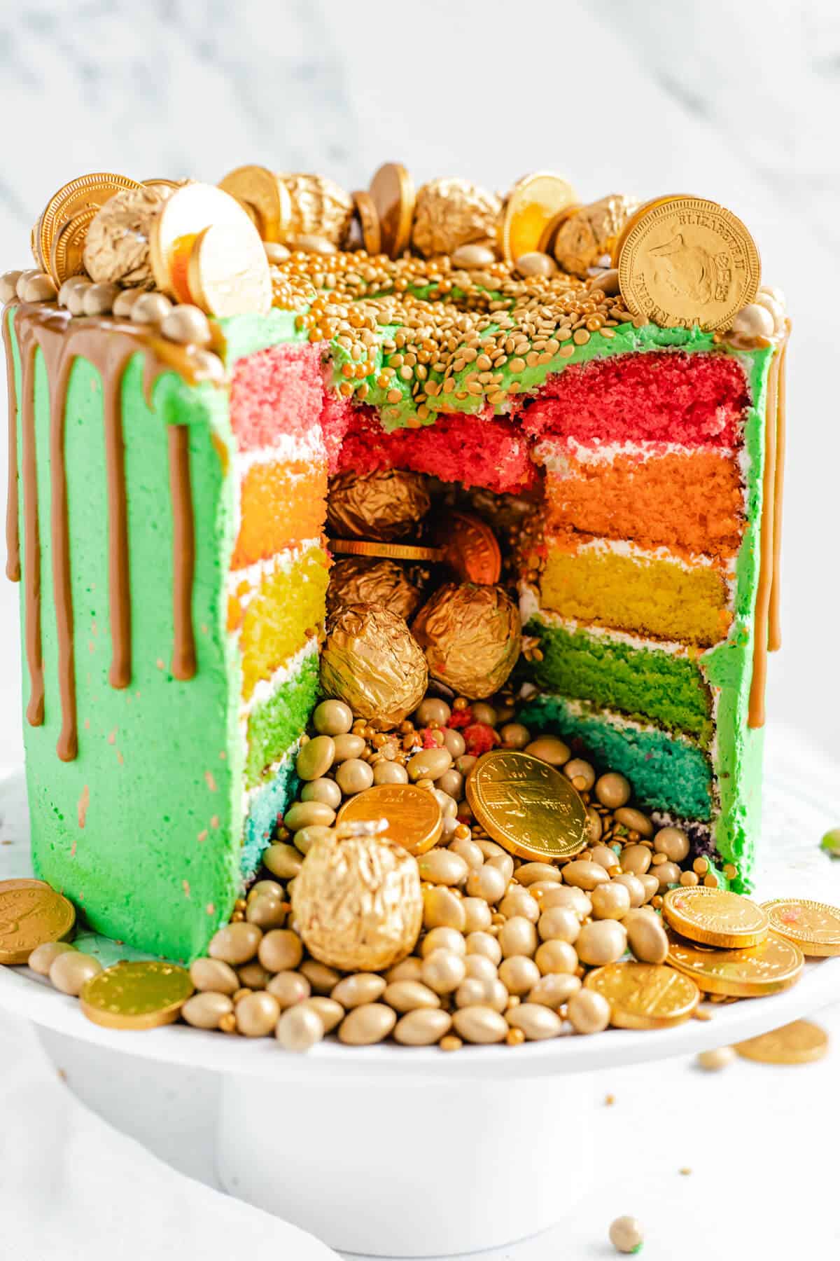 rainbow piñata cake with gold candies falling out