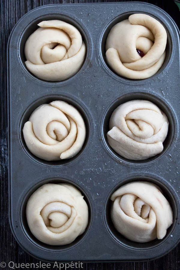 Wake up and smell the rose buns! Soft and fluffy rose-shaped buns filled with sweet raspberry jam. These Raspberry Rose Buns are an easy and gorgeous gift for Mothers Day! 