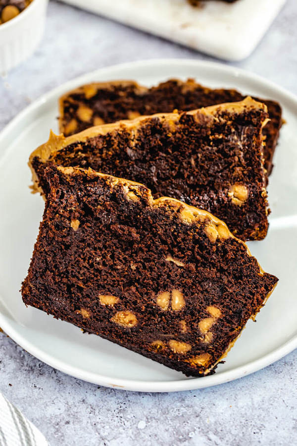 slices of chocolate peanut butter chip banana bread on a white plate