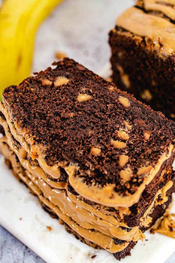 close up of stacked slices of peanut butter chip and chocolate chip banana bread