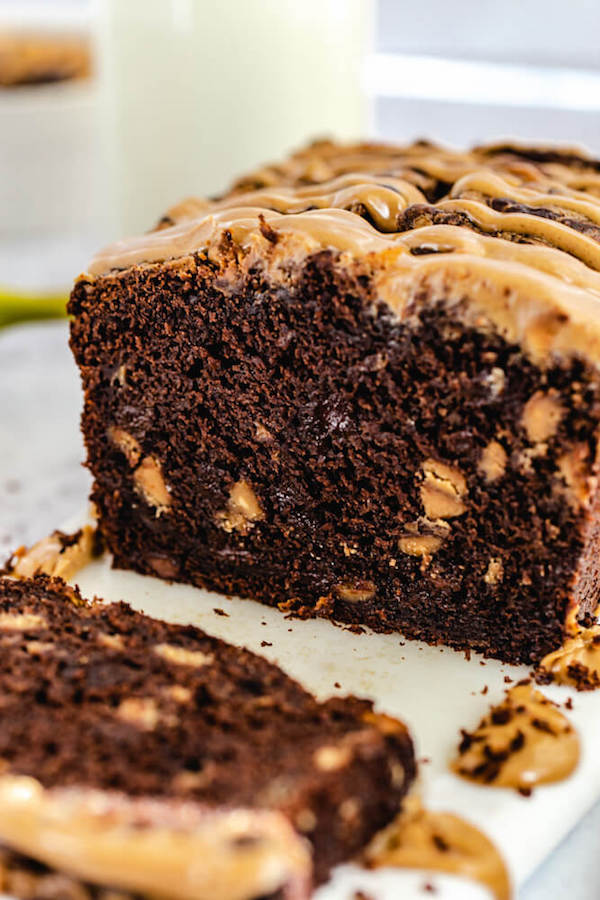 close up of sliced chocolate banana loaf on a marble platter