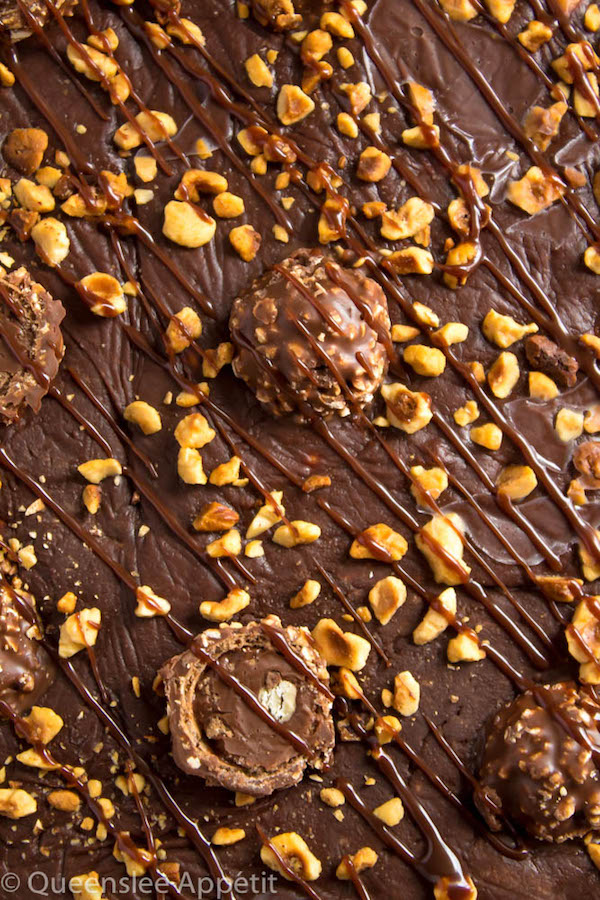 These Ferrero Rocher Fudge Brownies are the ultimate dessert bars! A Ferrero Rocher stuffed fudge brownie, topped with a creamy Nutella Fudge filled and topped with Ferrero Rochers and roasted hazelnuts. Take these bars to another level with a drizzle of silky Nutella Ganache and you’ve got the greatest brownie ever!  