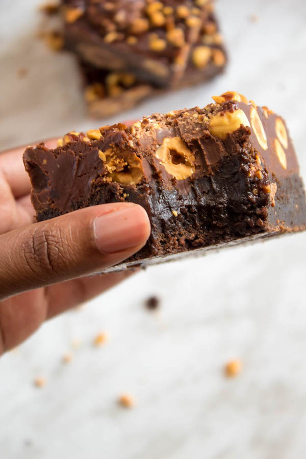 These Ferrero Rocher Fudge Brownies are the ultimate dessert bars! A Ferrero Rocher stuffed fudge brownie, topped with a creamy Nutella Fudge filled and topped with Ferrero Rochers and roasted hazelnuts. Take these bars to another level with a drizzle of silky Nutella Ganache and you’ve got the greatest brownie ever!  