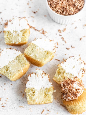 six halved cupcakes coated in coconut