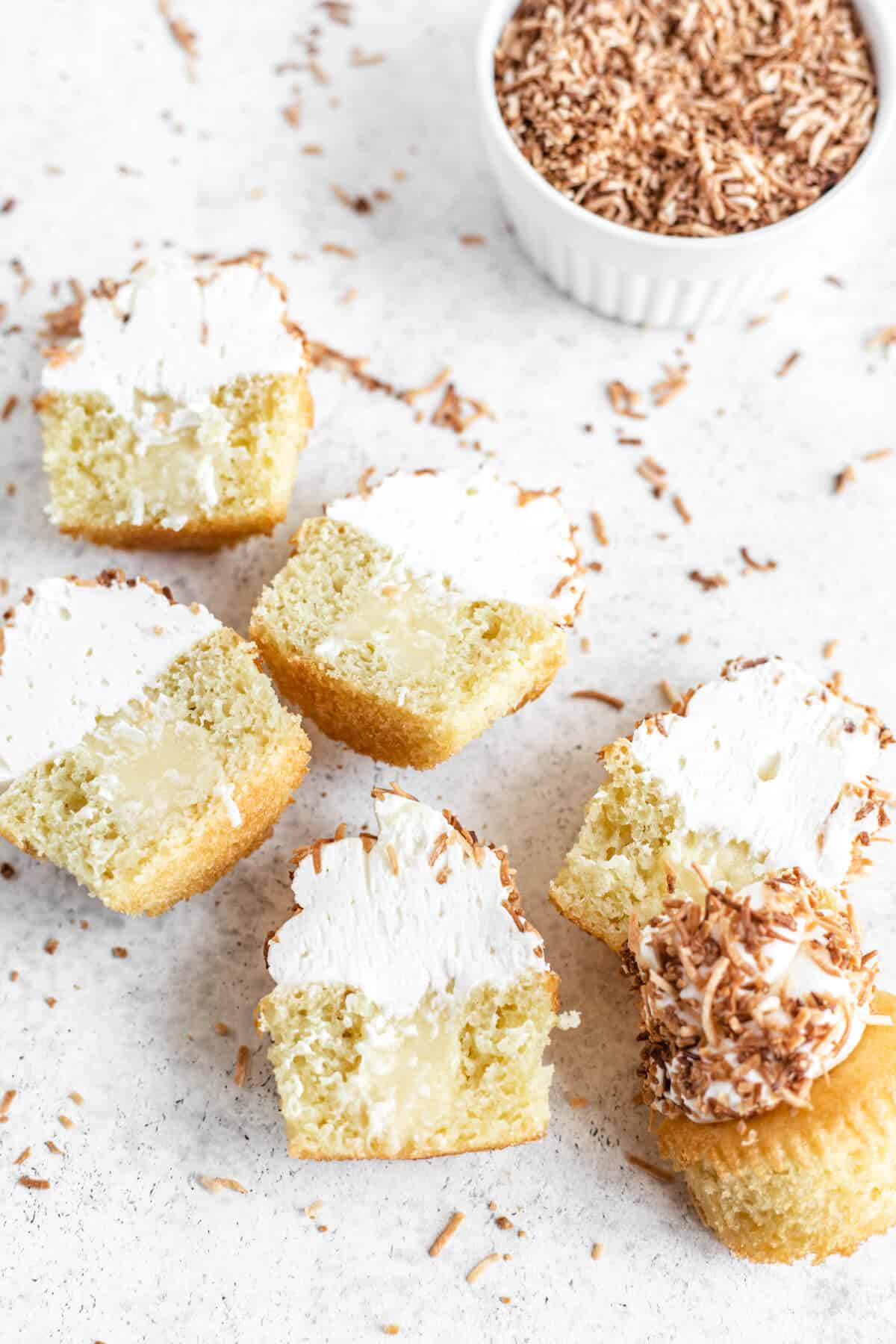 six halved cupcakes coated in coconut