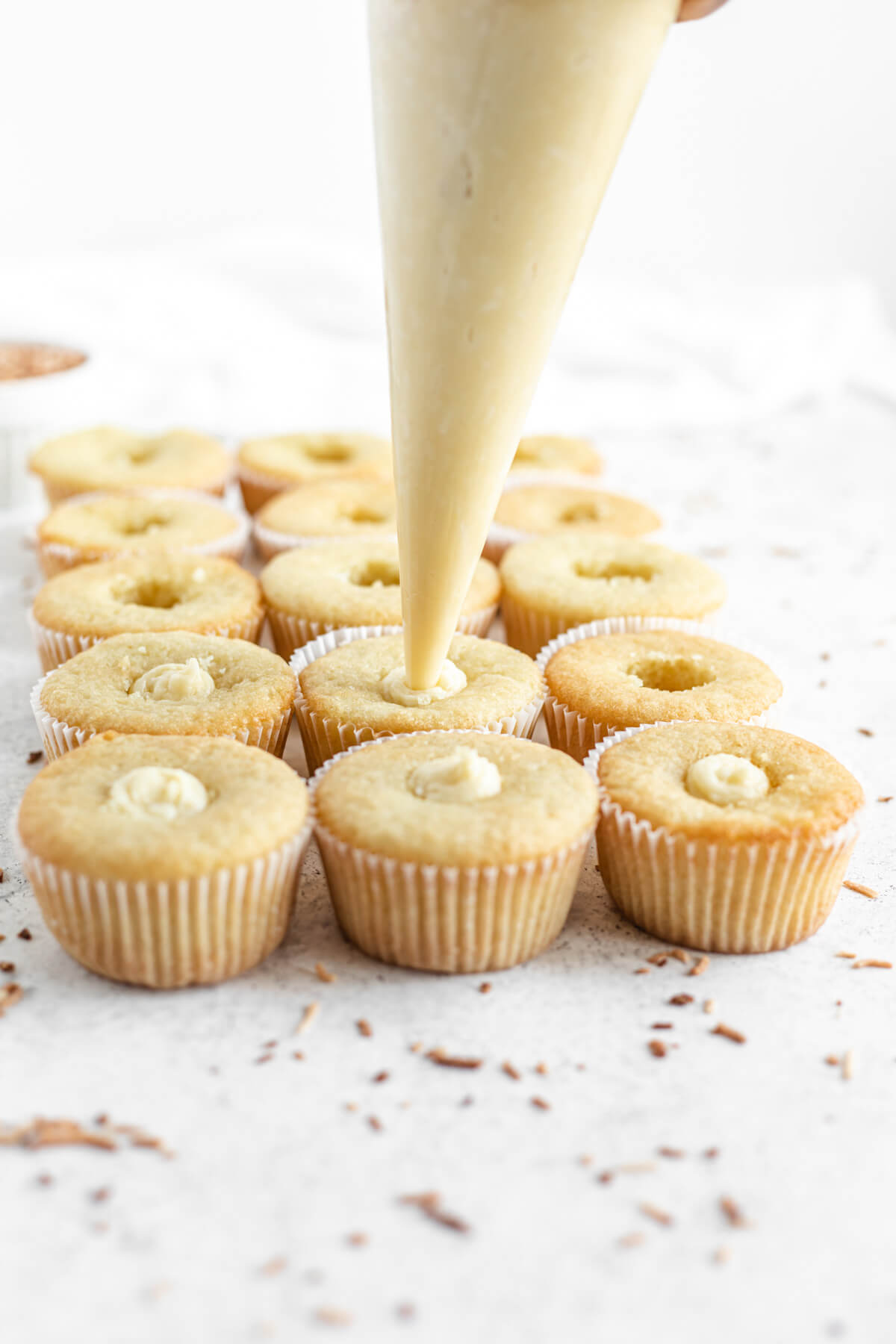 filling cupcakes with coconut custard