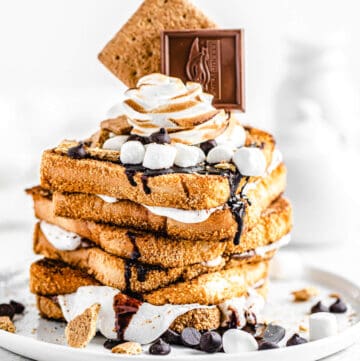 stack of marshmallow filled graham cracker French toast topped with chocolate, marshmallows and graham crackers