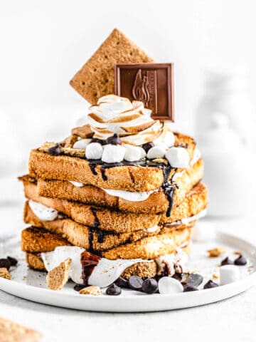 stack of marshmallow filled graham cracker French toast topped with chocolate, marshmallows and graham crackers