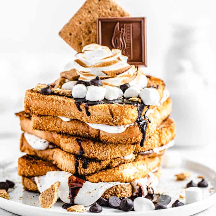 stack of marshmallow filled graham cracker French toast topped with chocolate, marshmallows and graham crackers