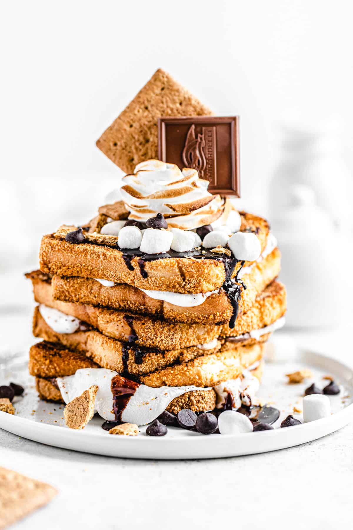 stack of marshmallow filled graham cracker French toast topped with chocolate, marshmallows and graham crackers