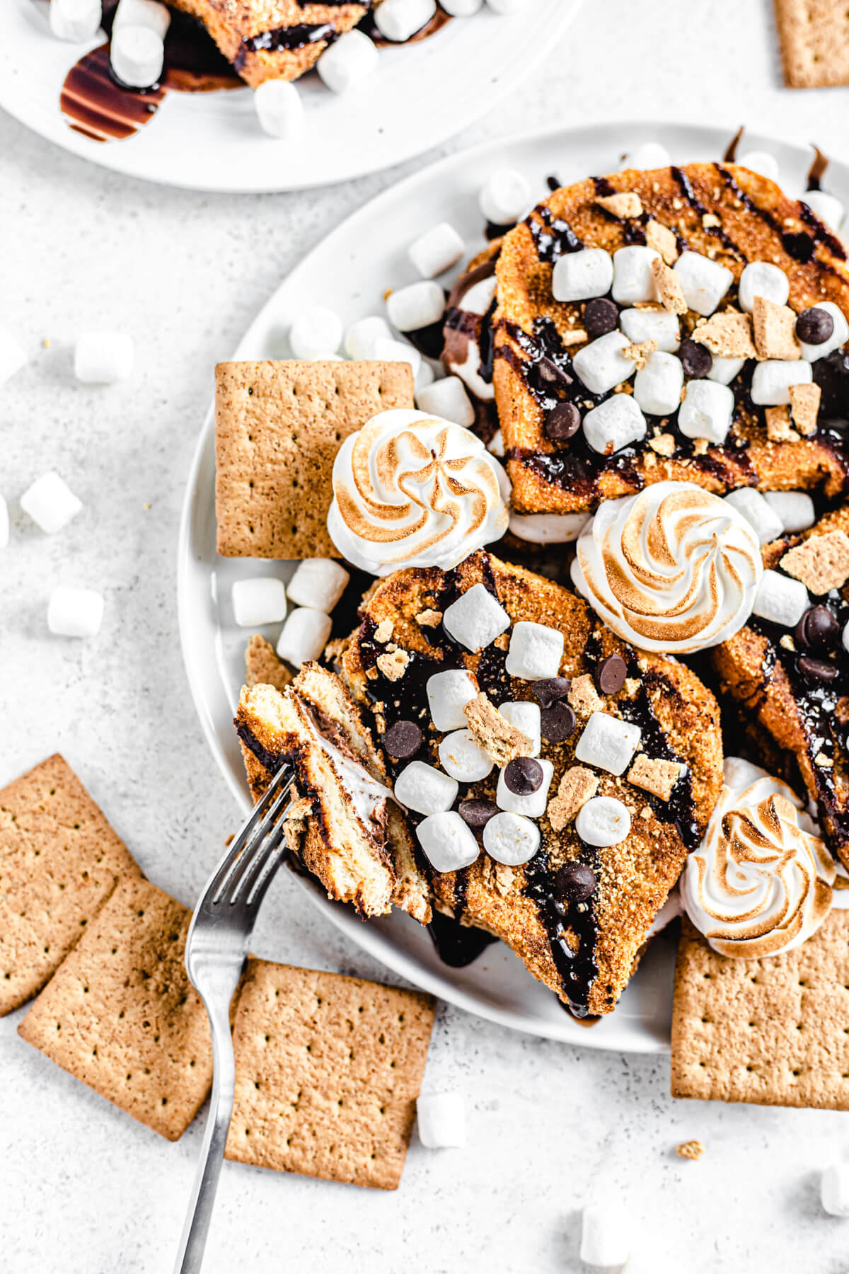 French toast on a white platter with a piece taken off of one