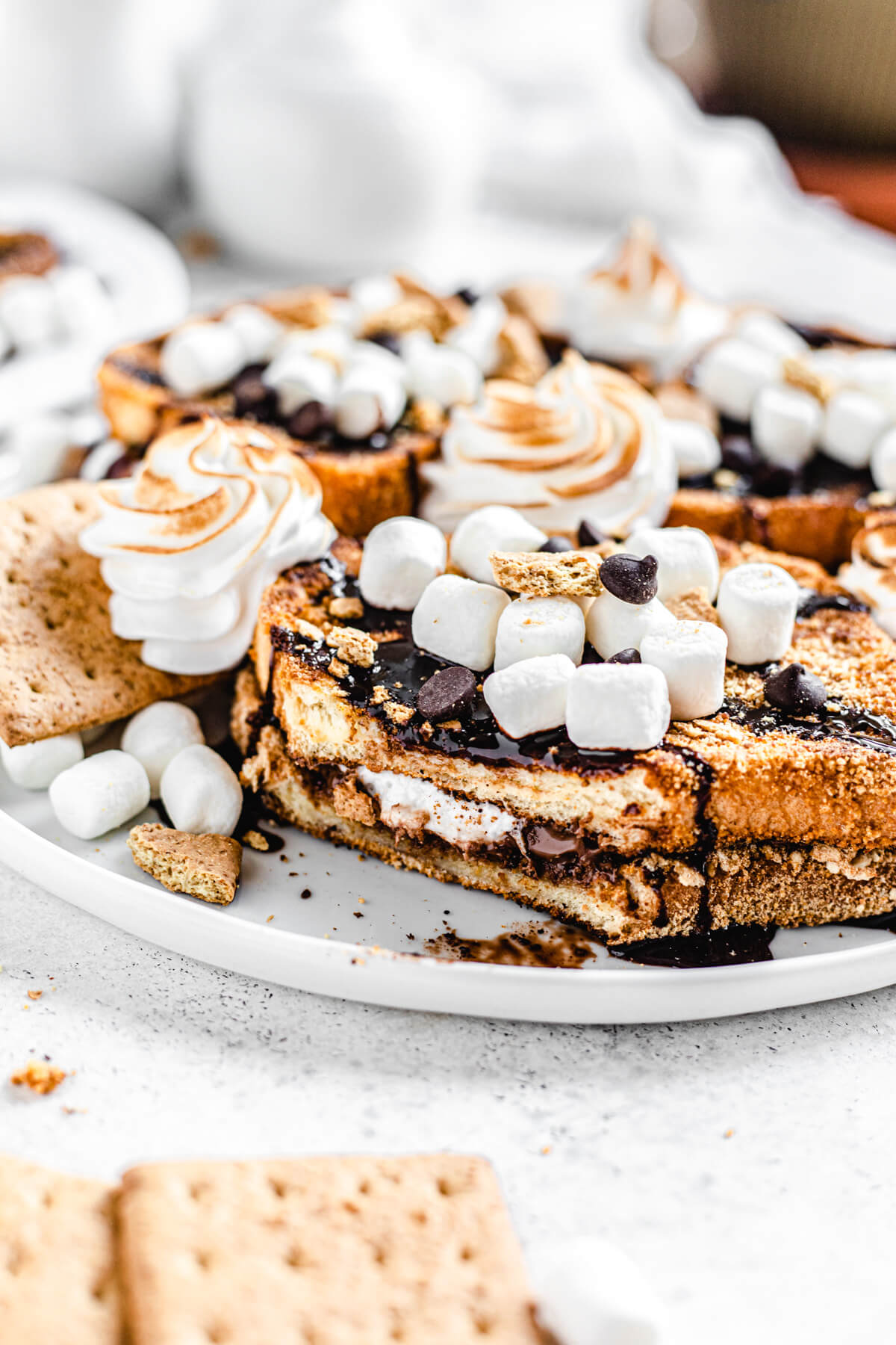 French toast on a plate with bite removed to show chocolate marshmallow filling