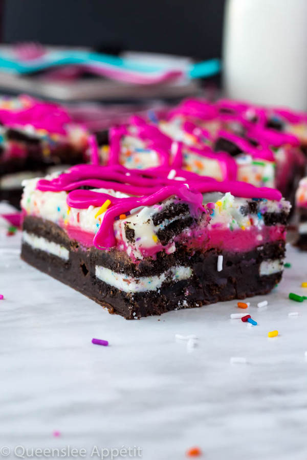 These Birthday Cake Oreo Fudge Brownies are super rich and decadent. Layers of fudgy Birthday Cake Oreo stuffed brownies and Funfetti fudge are topped with more Oreos and plenty of sprinkles. Drizzle these bars with hot pink candy melts and you’ve got a party in a brownie!