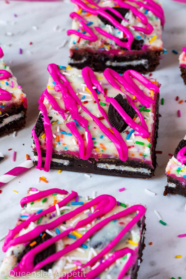 These Birthday Cake Oreo Fudge Brownies are super rich and decadent. Layers of fudgy Birthday Cake Oreo stuffed brownies and Funfetti fudge are topped with more Oreos and plenty of sprinkles. Drizzle these bars with hot pink candy melts and you’ve got a party in a brownie!