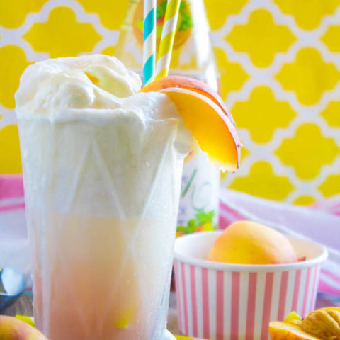 These Peaches and Cream Floats are a super delicious and refreshing drink. Scoops of creamy vanilla ice cream topped with a sparkling peach beverage and club soda. This fizzy drink is perfect for a hot summer day!  