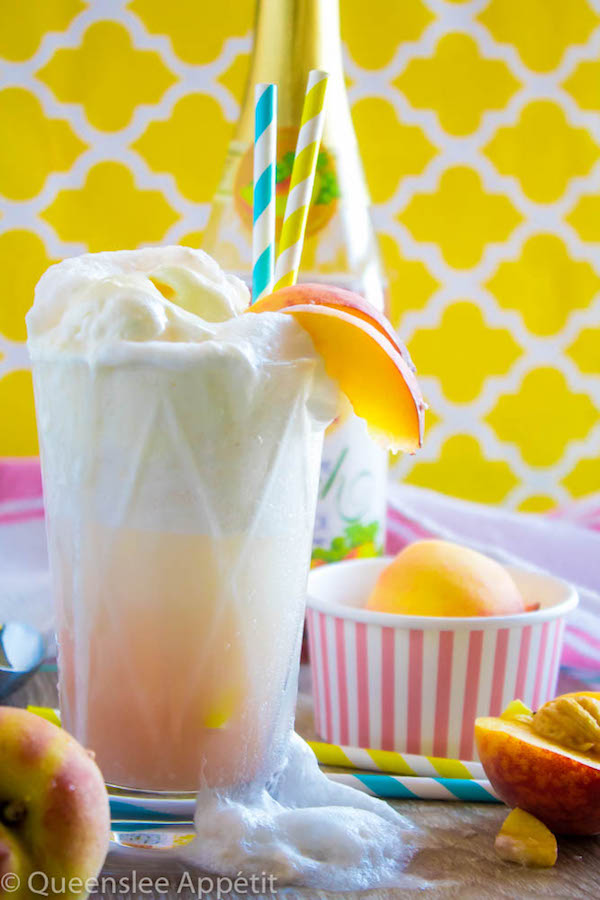 These Peaches and Cream Floats are a super delicious and refreshing drink. Scoops of creamy vanilla ice cream topped with a sparkling peach beverage and club soda. This fizzy drink is perfect for a hot summer day!  