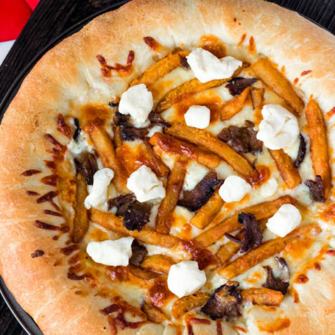 This classic Canadian dish just got better! This Poutine Pizza is topped with poutine gravy, shredded mozzarella and white cheddar cheese, crispy fries, steak and chunks of white cheddar cheese curds! To take it to the next level, the crust is stuffed with cheese! 