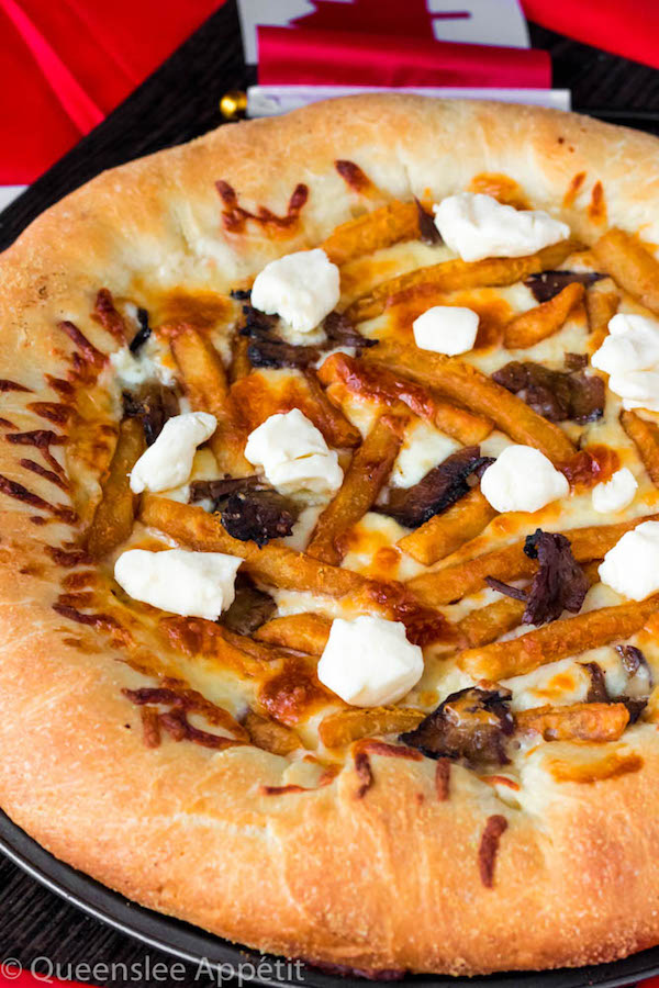 This classic Canadian dish just got better! This Poutine Pizza is topped with poutine gravy, shredded mozzarella and white cheddar cheese, crispy fries, steak and chunks of white cheddar cheese curds! To take it to the next level, the crust is stuffed with cheese! 