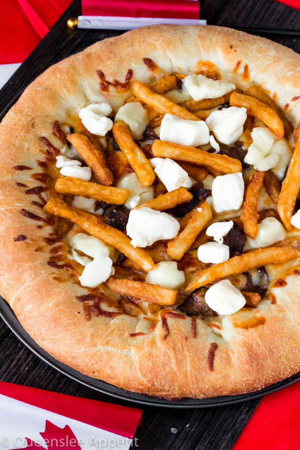 This classic Canadian dish just got better! This Poutine Pizza is topped with poutine gravy, shredded mozzarella and white cheddar cheese, crispy fries, steak and chunks of white cheddar cheese curds! To take it to the next level, the crust is stuffed with cheese! 