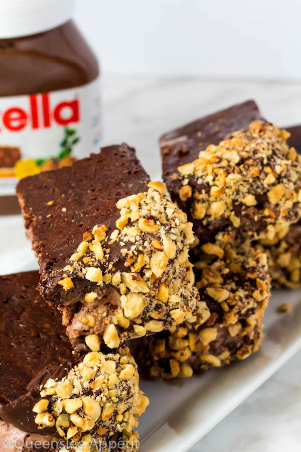 These Nutella Brownie Ice Cream Sandwiches feature Ferrero Rocher stuffed chocolate ice cream sandwiched between two fudgy Nutella brownies. These lovelies are taken to the next level with a chocolate/hazelnut coating! A fun treat for the summertime! 